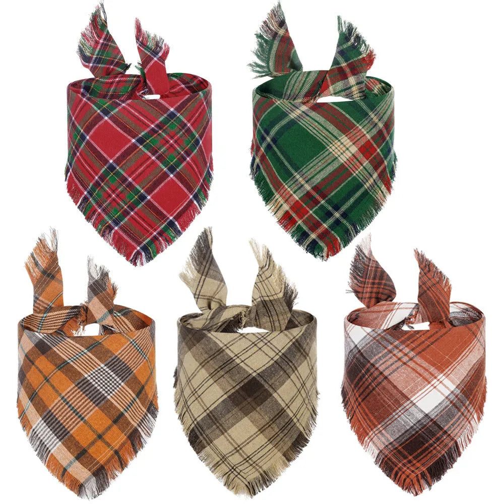 Brown, green, orange, red, and yellow plaid dog bandana with tassels on the edges.