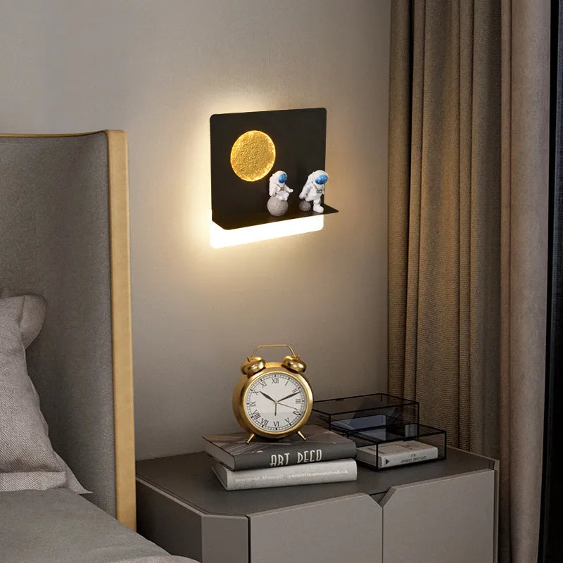 Astronaut-shaped wall lamp with a small shelf, shown in a choice of round or square, black or white finishes.