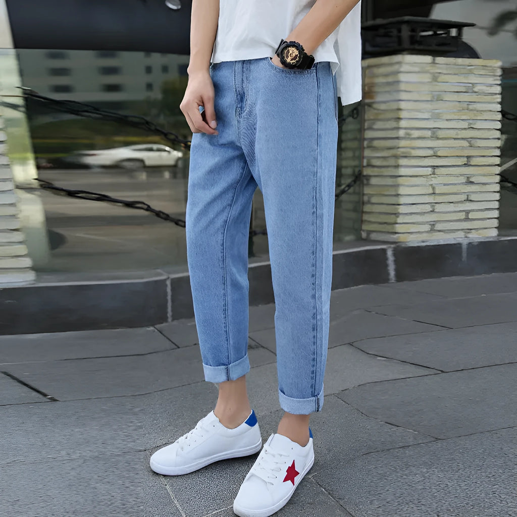 Men's black straight leg harem jeans with college-inspired styling on hanger