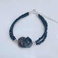 Natural obsidian climbing cat bracelet with hand-carved design and adjustable fit