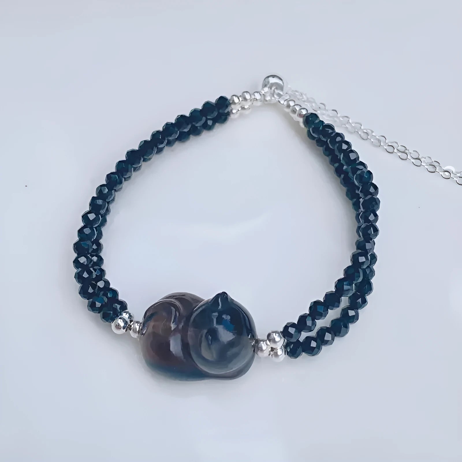 Natural obsidian climbing cat bracelet with hand-carved design and adjustable fit