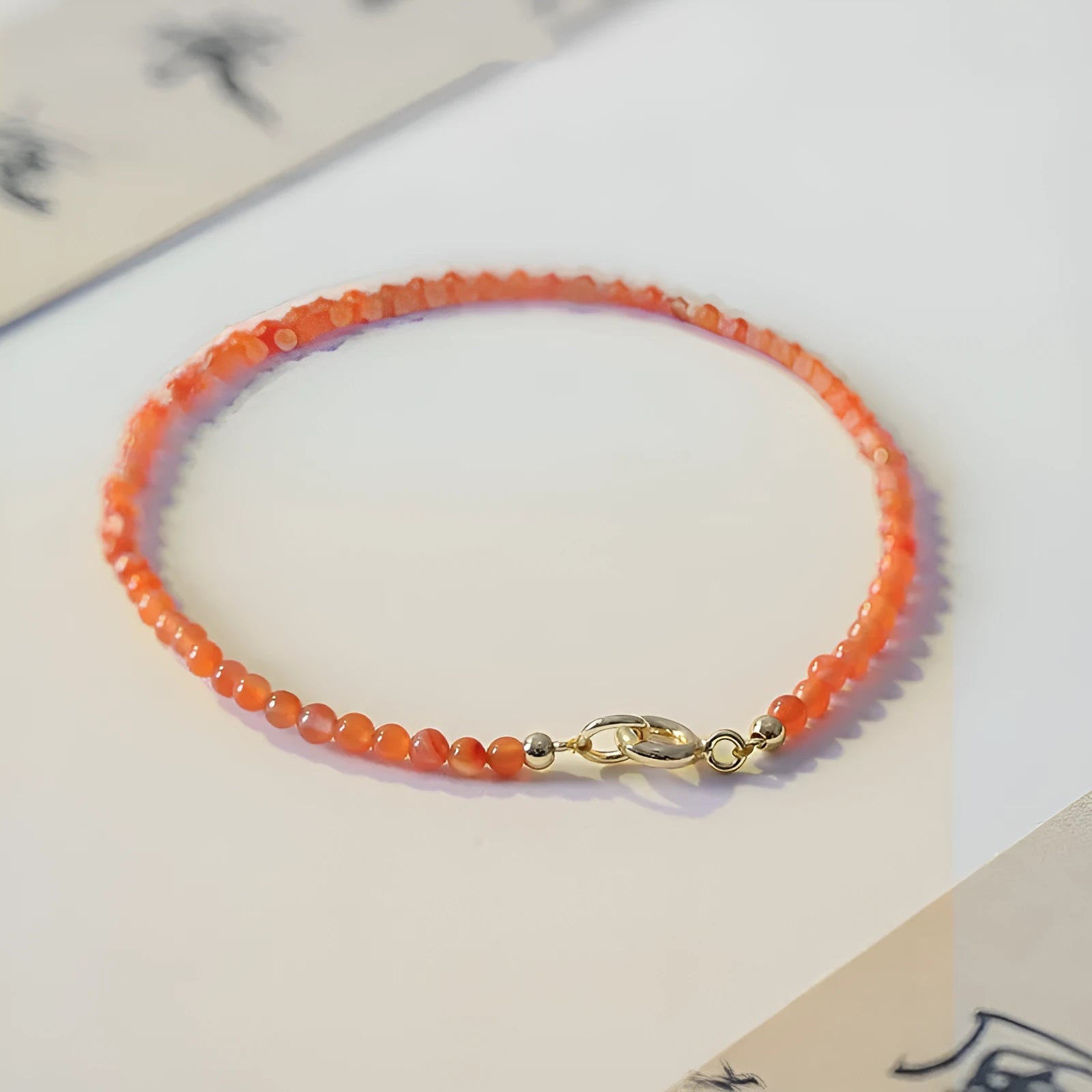 Women's retro-style bracelet featuring a polished natural southern red agate stone on a band, shown in cherry red and persimmon red colour variants.