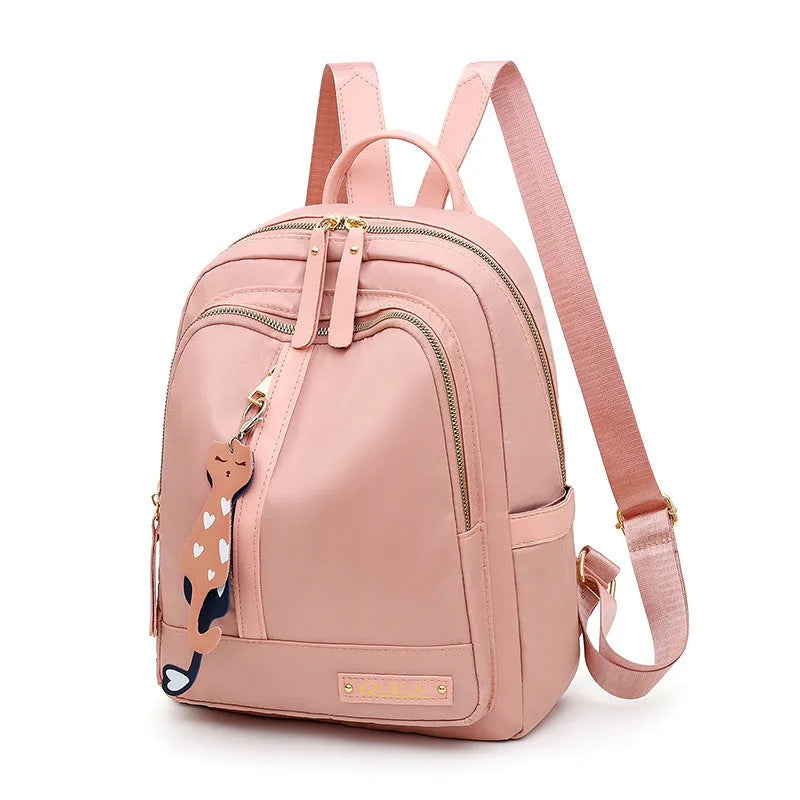 Black nylon casual backpack with external pockets, shown with adjustable straps and a soft handle.