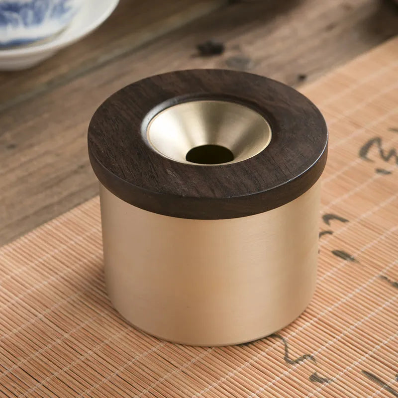 Copper retro ashtray with wooden lid showing central hole for ash collection