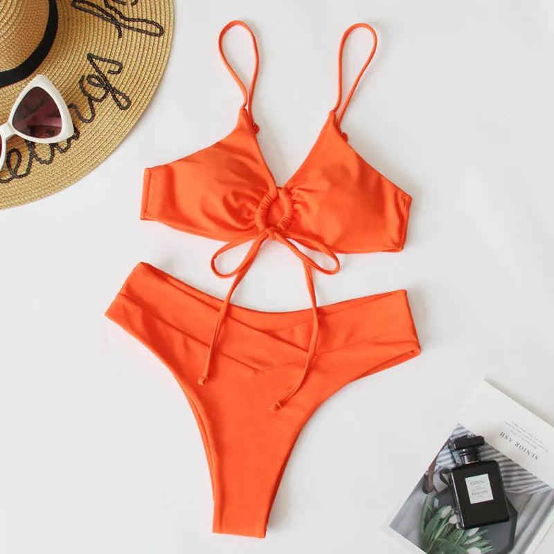 Women's orange tied bow bikini with halter neck top and high-cut briefs on mannequin
