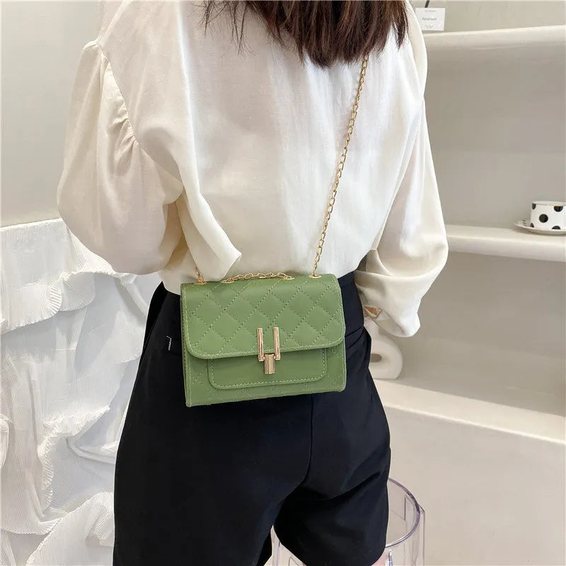 Women's crossbody bag with diamond lattice chain design in PU leather showing black colour option