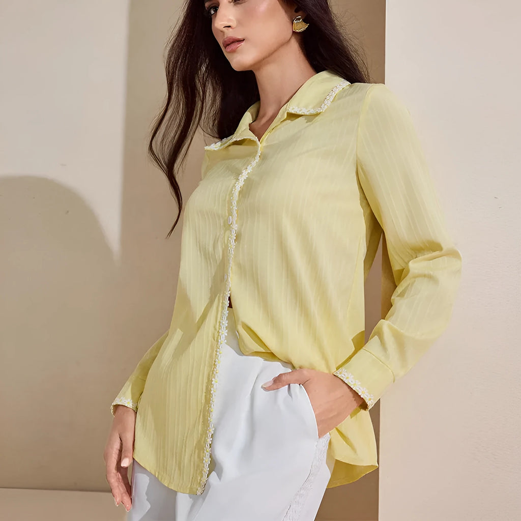 Women's solid yellow lace long-sleeved cardigan top with stitching detail on a plain background