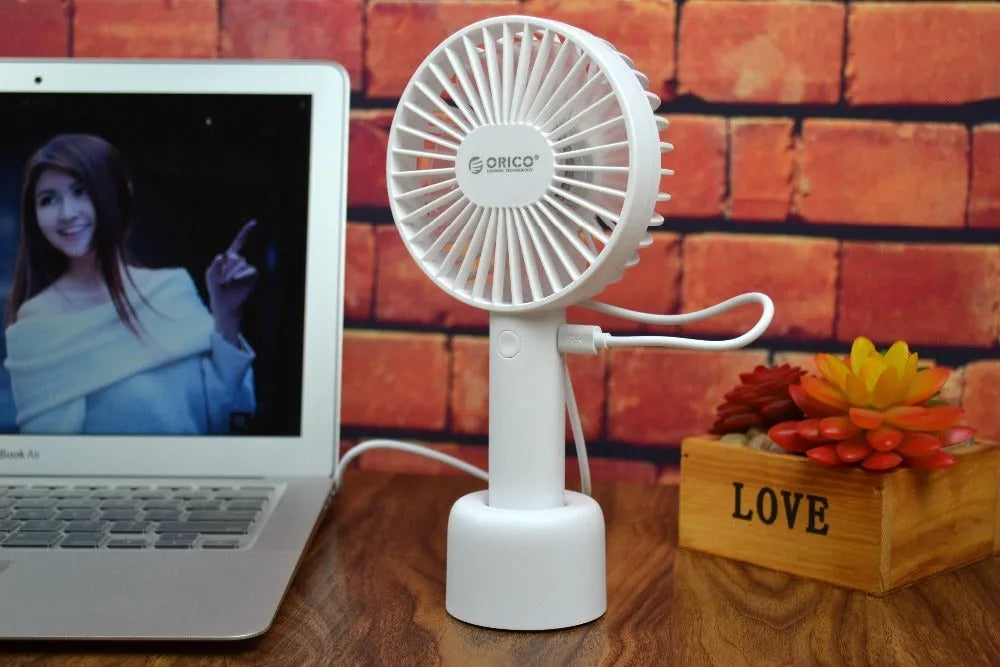 White ORICO FH1 portable USB rechargeable desk fan on a table