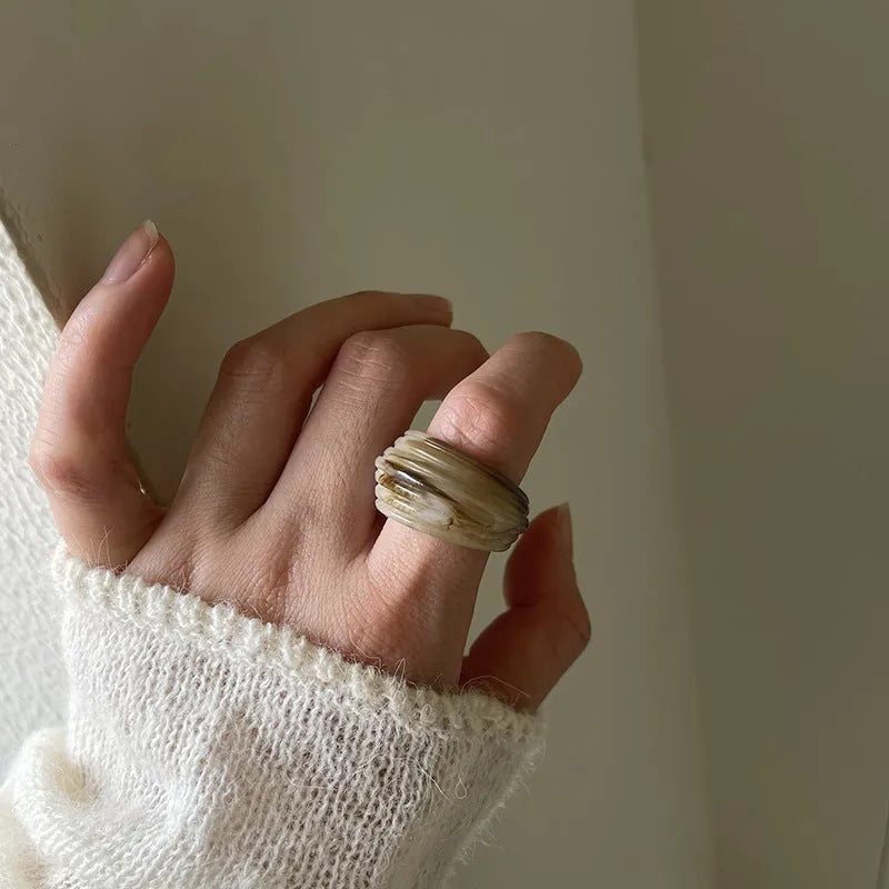 Geometric resin wide ring with irregular Chinese-inspired design in brown and white colours