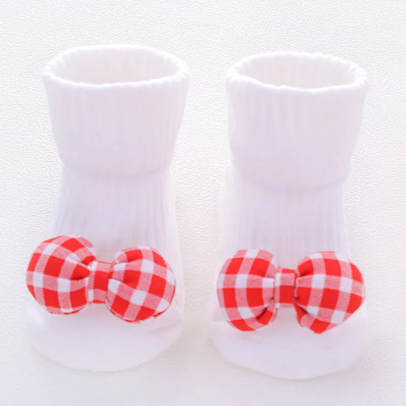 Cotton baby socks with non-slip soles in multiple designs including bows, stars, and animal prints.