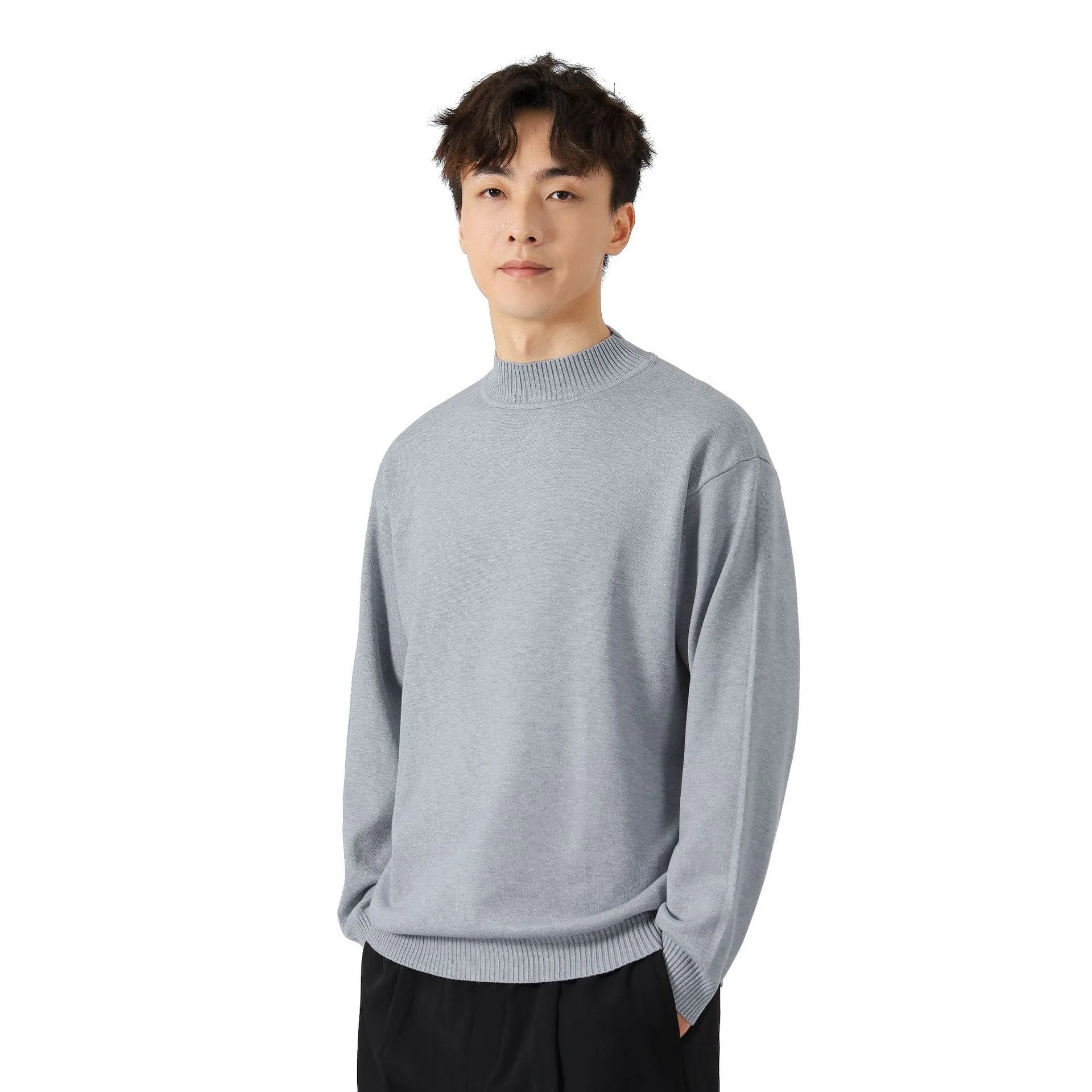 Man wearing a loose-fit army green long sleeve pullover sweater for casual autumn wear.