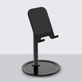 Silver white aluminium alloy mobile phone stand holding a smartphone on a desk