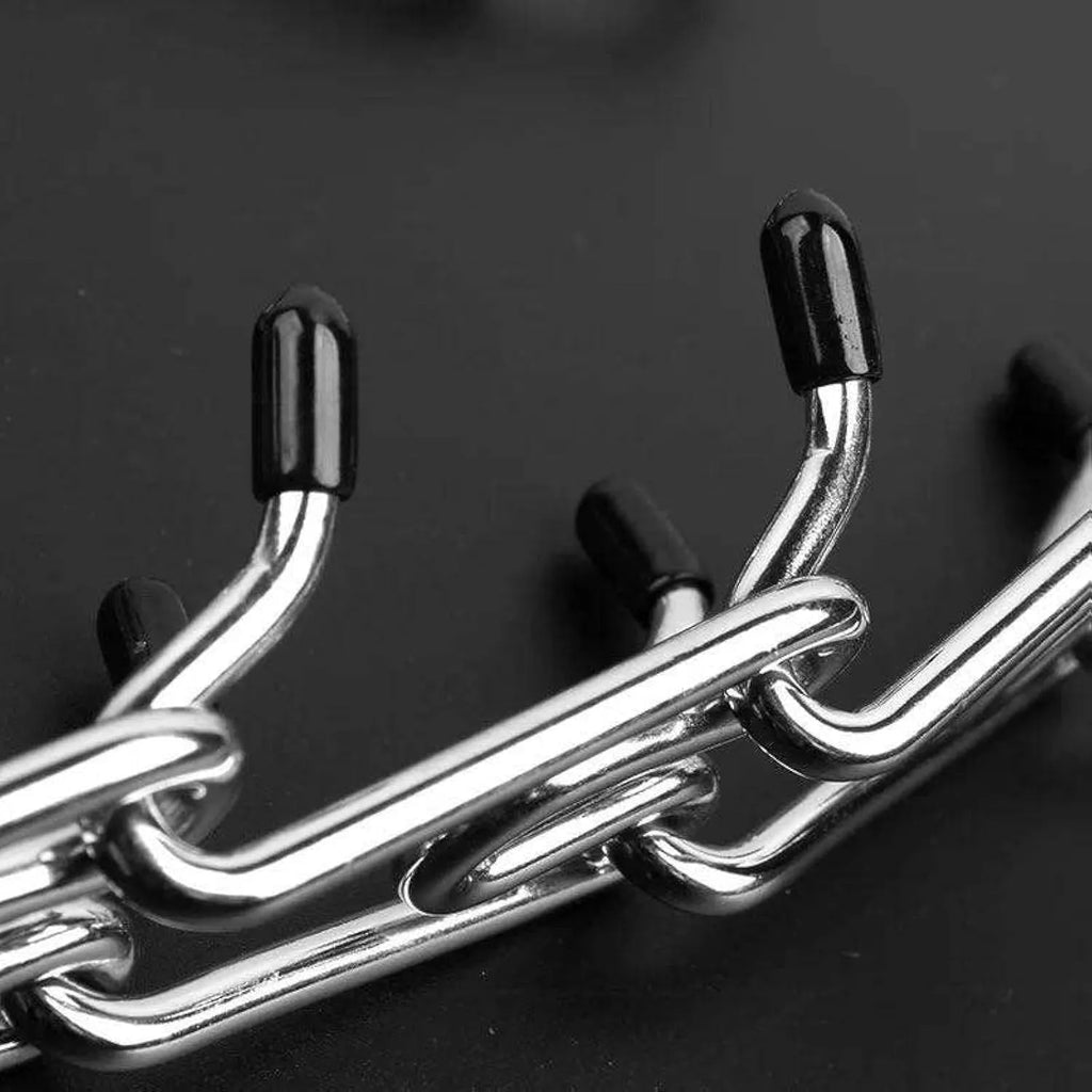 Stainless steel dog prong collar with adjustable chain links and black rubber comfort tips, laid flat to show sizing.