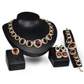 Gold-tone bridal jewellery set with crystal pendant necklace, earrings, ring, and bracelet with green red zircon stones