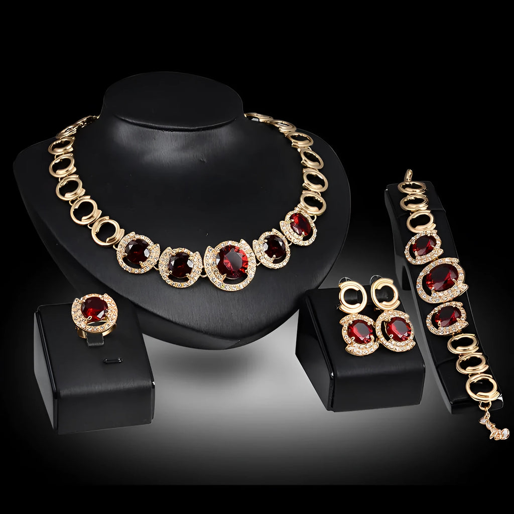 Gold-tone bridal jewellery set with crystal pendant necklace, earrings, ring, and bracelet with green red zircon stones