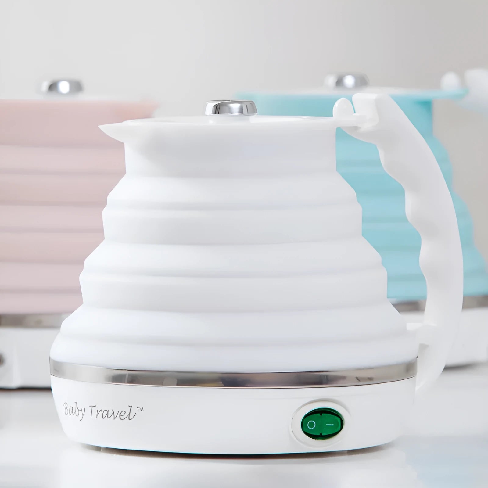Foldable electric kettle 555ml in blue silicone collapsed on table with push button and short power cord