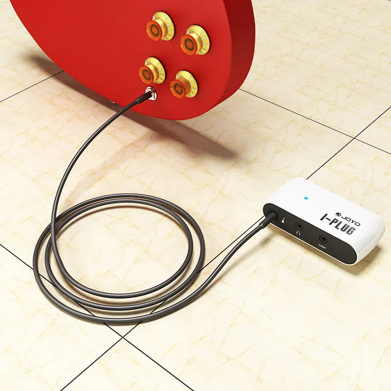 White metal distortion headphone amplifier unit measuring 93mm with connector and adapter