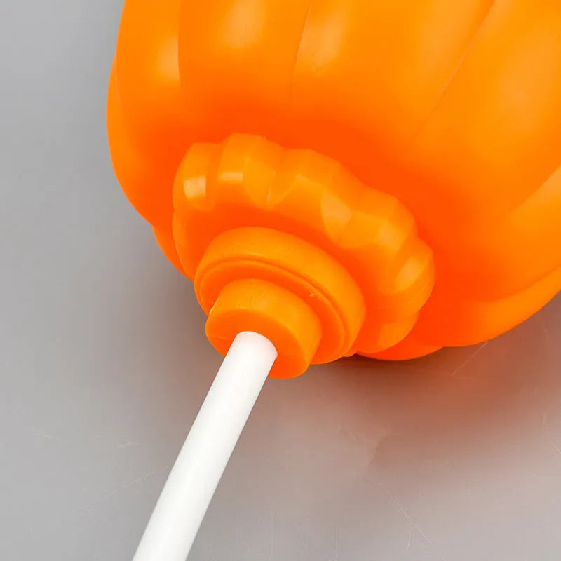 Plastic pumpkin lamp with USB power cable showing yellow or purple light options