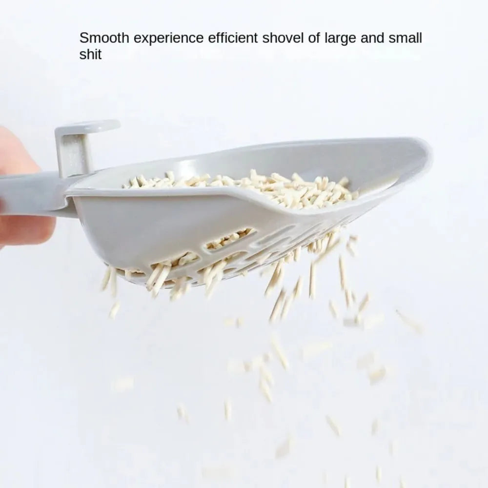 Grey plastic cat litter scoop sitting in its matching base tray