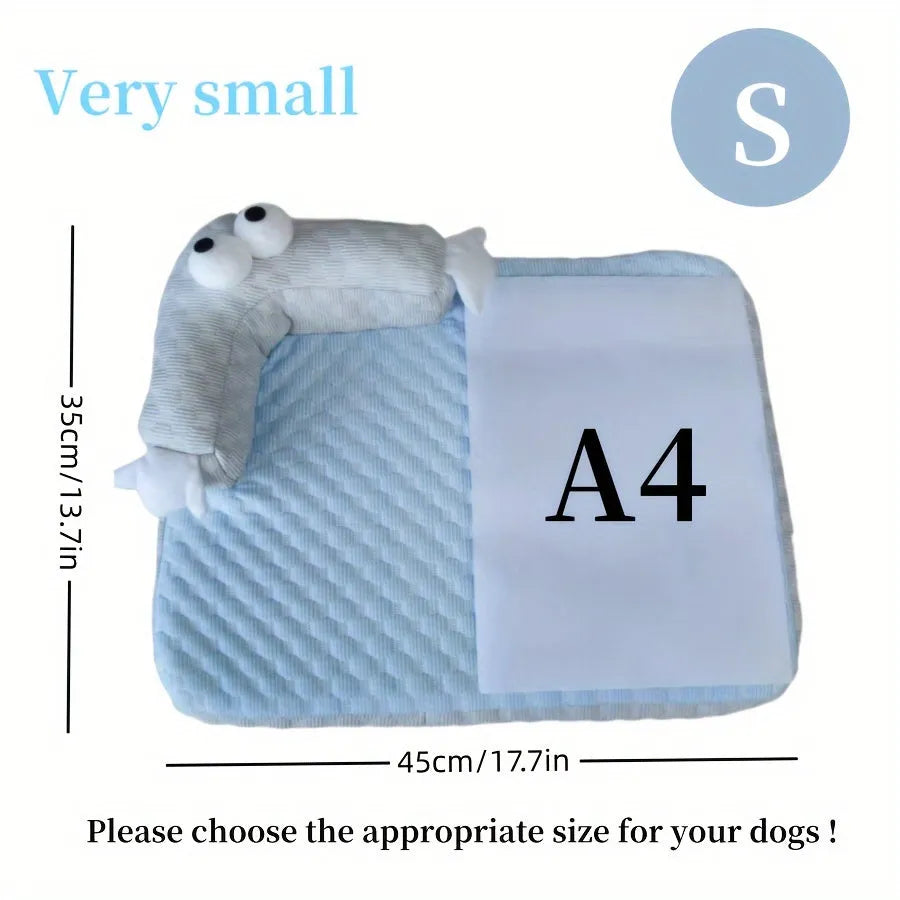 Blue pet cooling pad with big-eyed monster design, shown on a wooden floor.