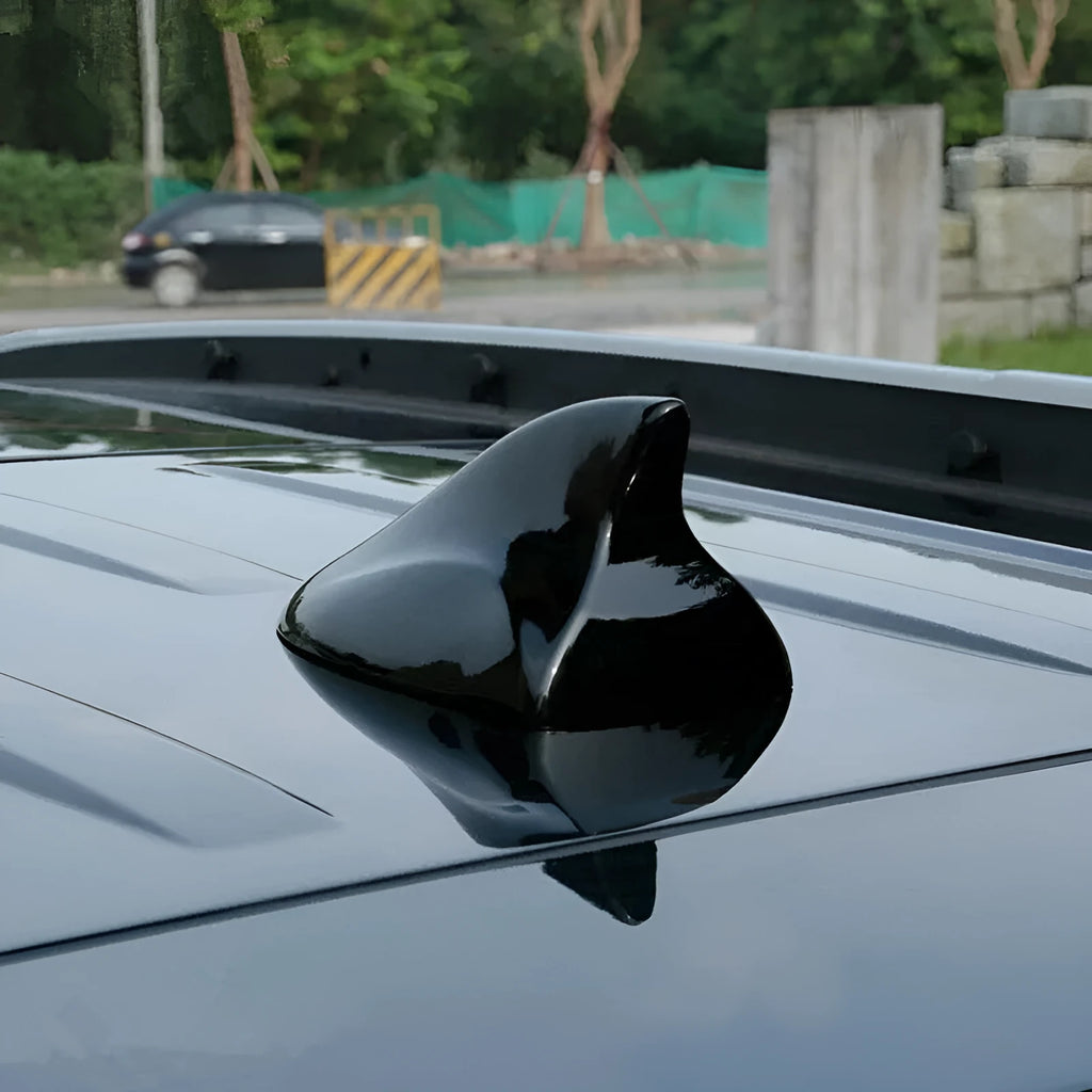 Black ABS car shark fin antenna with adhesive base for stick-on installation on a white car roof