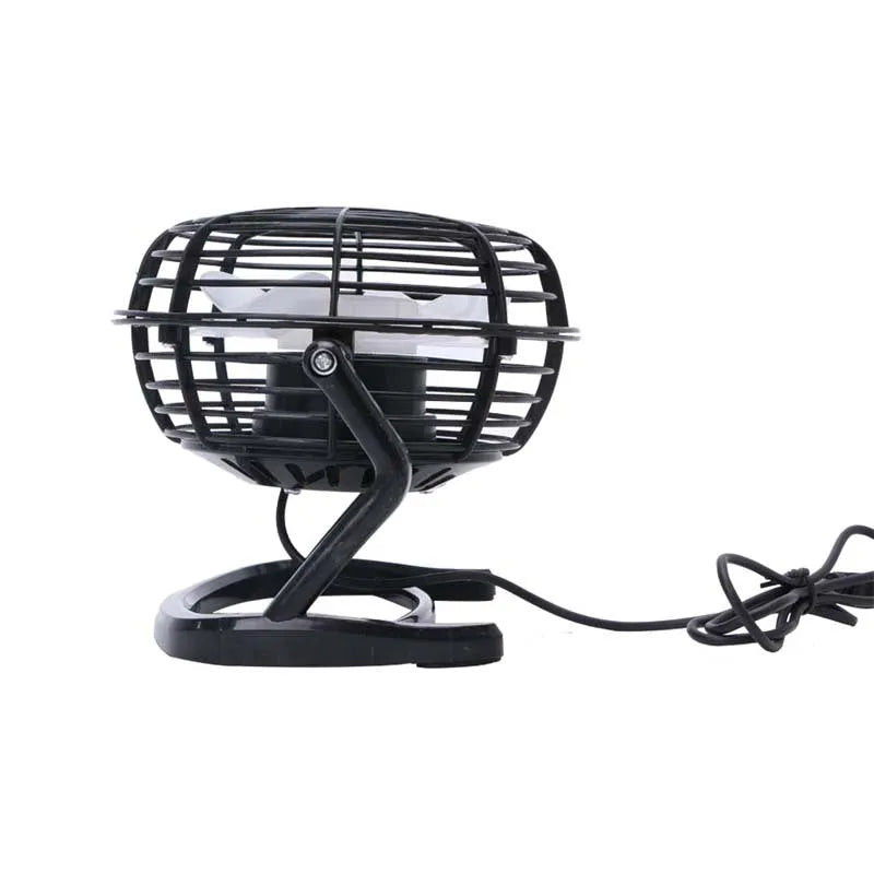 Mini black USB desk fan with adjustable tilt, shown on a desk next to a laptop.