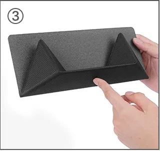 Blue or grey portable foldable laptop cooling stand bracket with anti-slip pads on a flat surface.