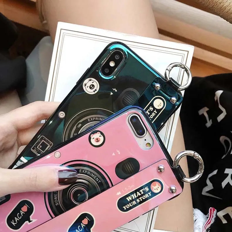 TPU iPhone case with retro camera design in blue or pink, back cover style, optional wrist strap.