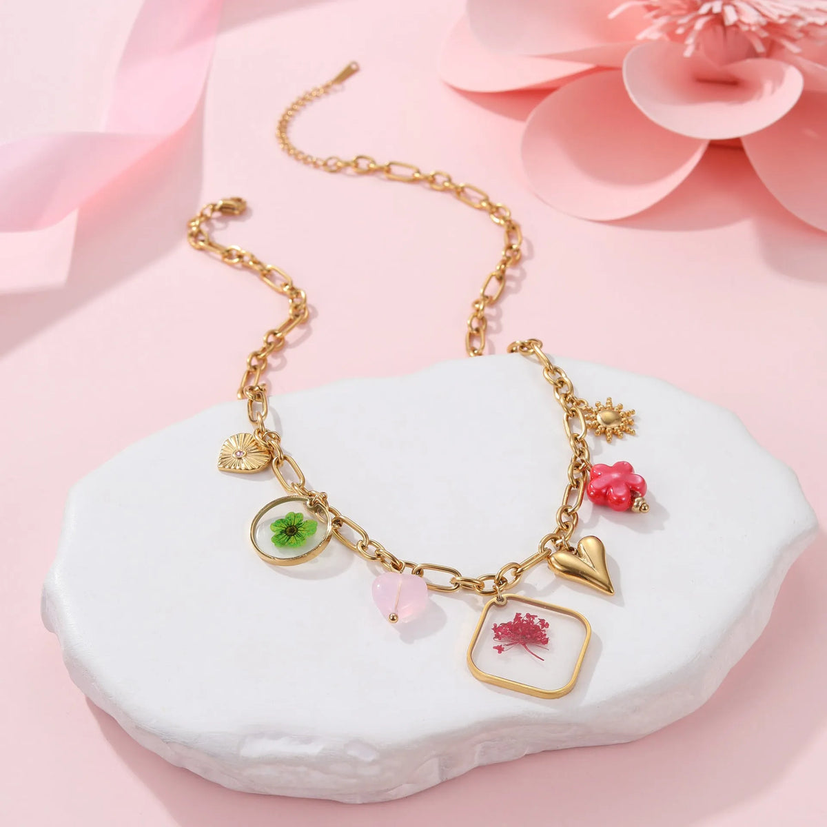 Stainless steel necklace with geometric epoxy flower pendant and 18K gold electroplated finish on a regular chain