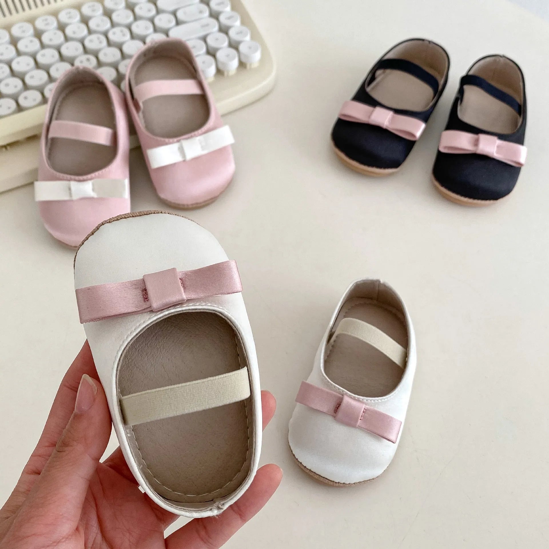 Cute baby butterfly knot shoes in solid colour with bow detail, breathable cloth and rubber sole