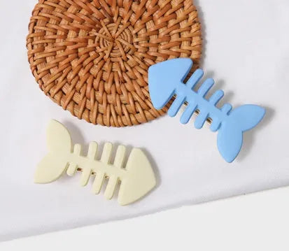 A minimalist fishbone design duckbill clip hair barrette in a muted candy colour.