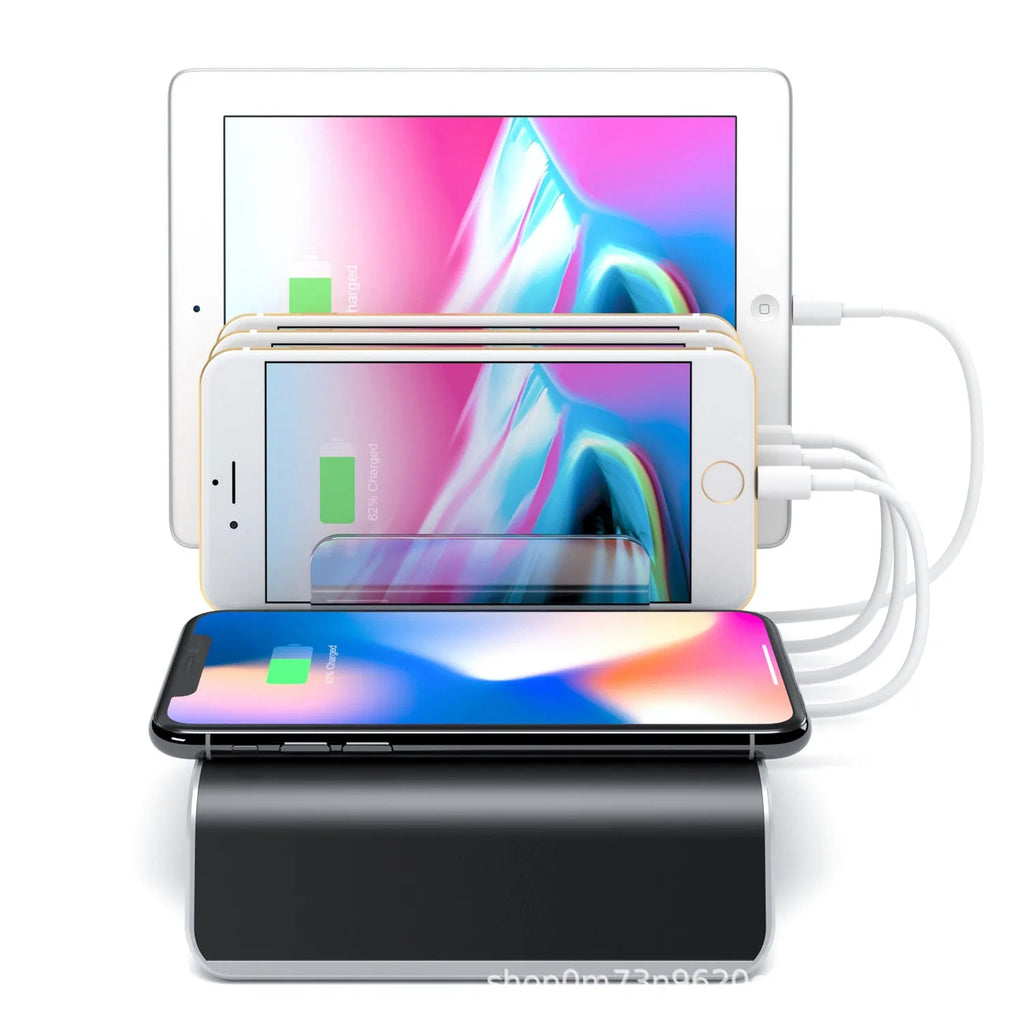 Black universal mobile phone and tablet charging stand on a desk.