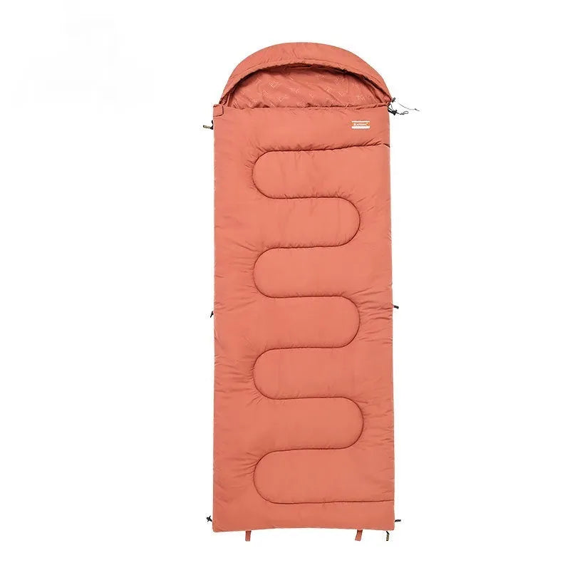 Ochre and olive green cotton sleeping bag quilt laid out flat, showing its quilted texture and portable size.
