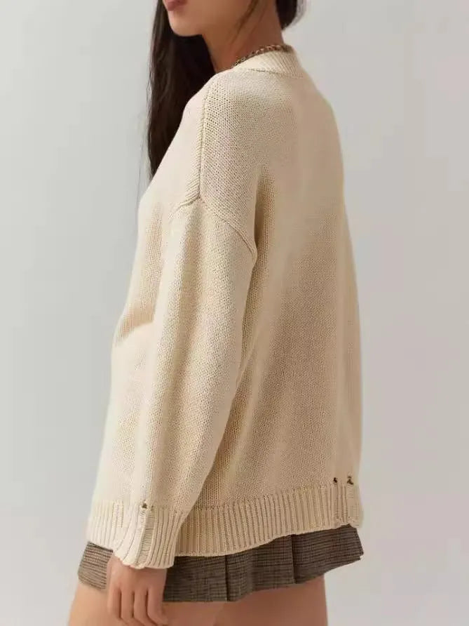 Milky white women's loose-fitting acrylic sweater with jacquard pattern and long sleeves.
