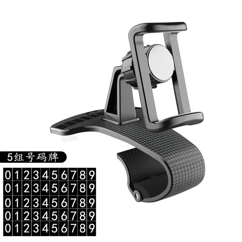 Black universal car phone mount with 360-degree rotating head on a car dashboard.