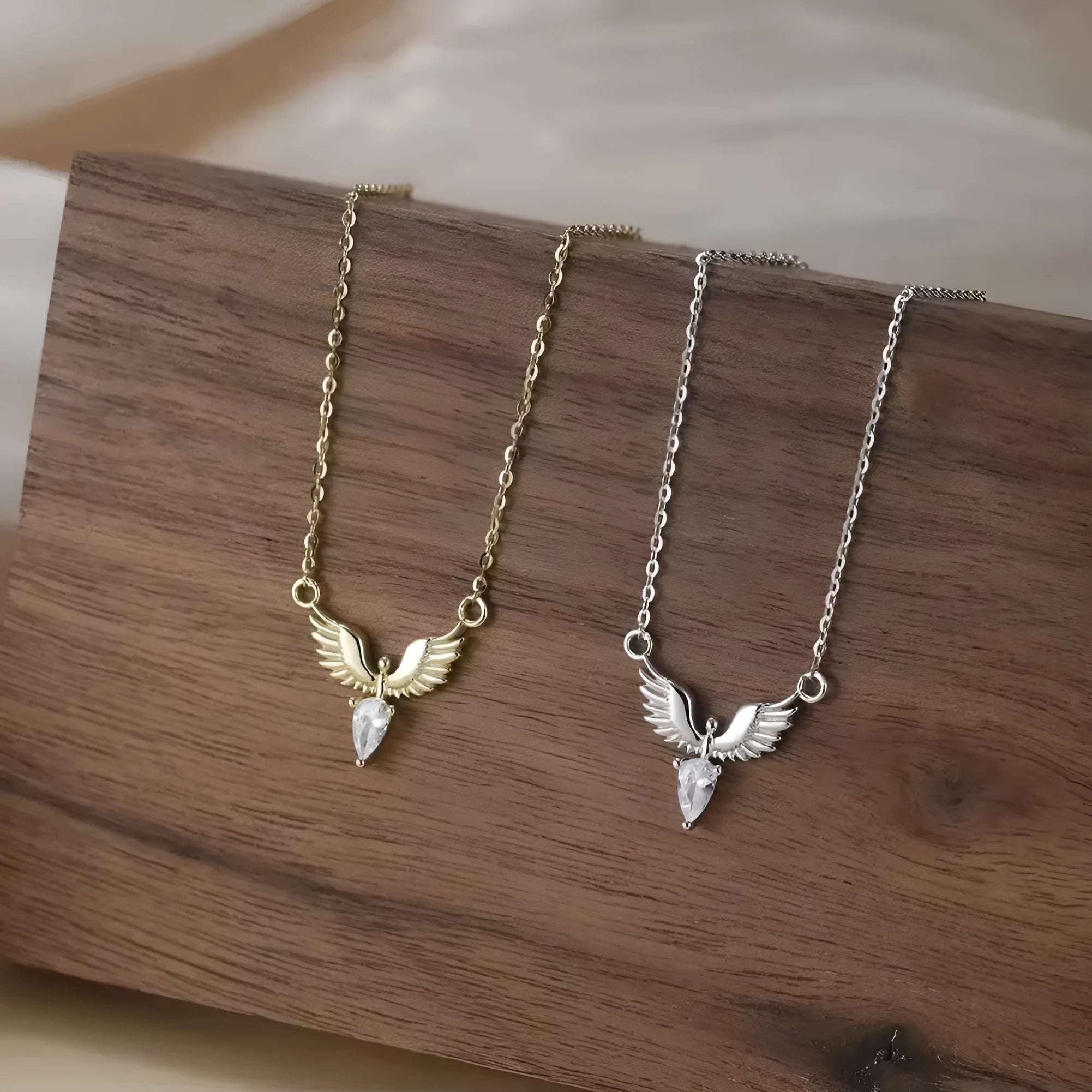 Close-up of an adjustable silver eagle pendant necklace on a textured background, showing the O-ring chain.