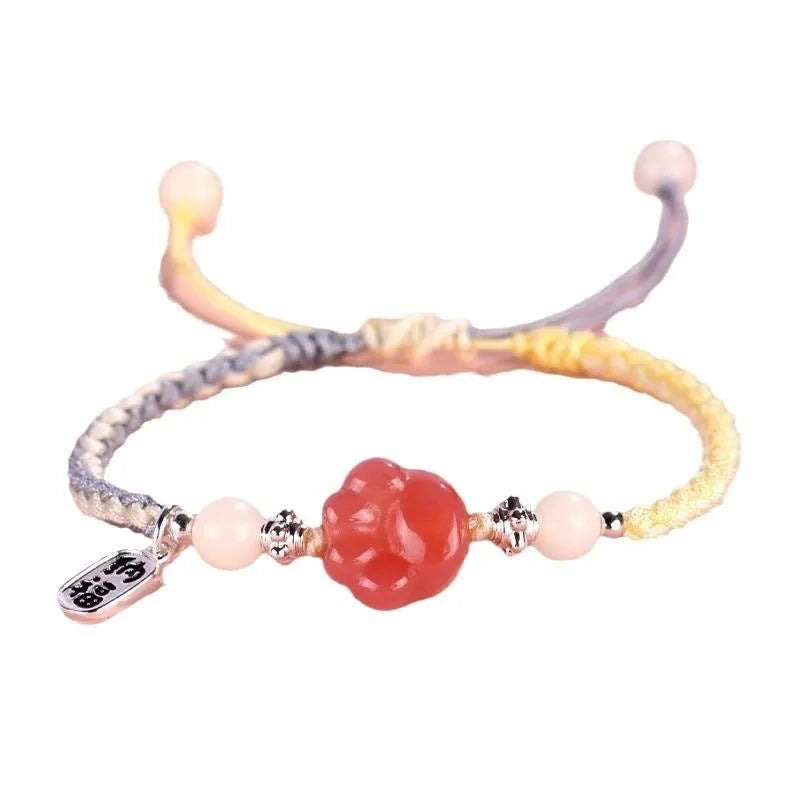 Handmade red cat's paw charm bracelet with pink woven band for couples.