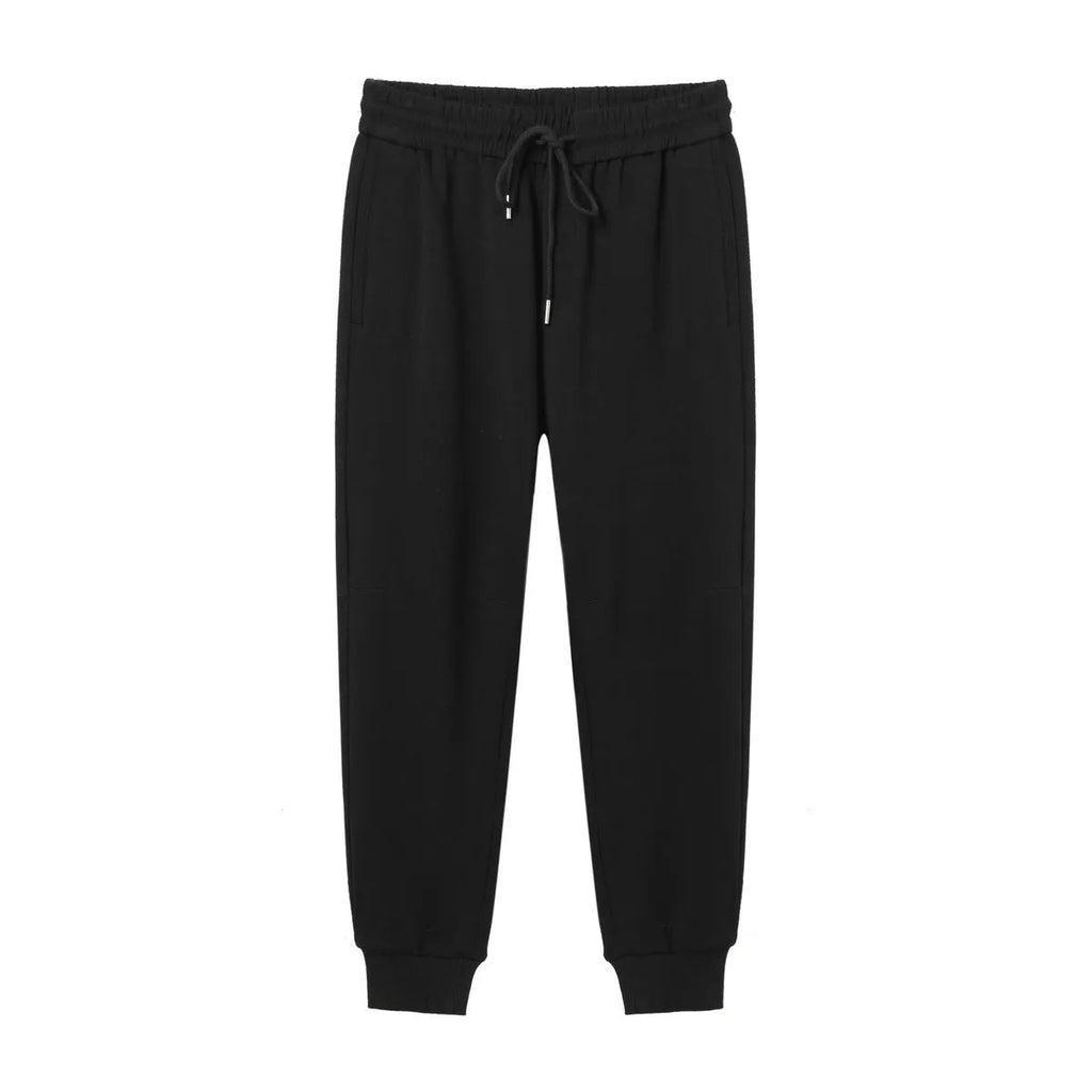 Men's mid-waist drawstring casual pants in black cotton blend, loose nine-length fit.