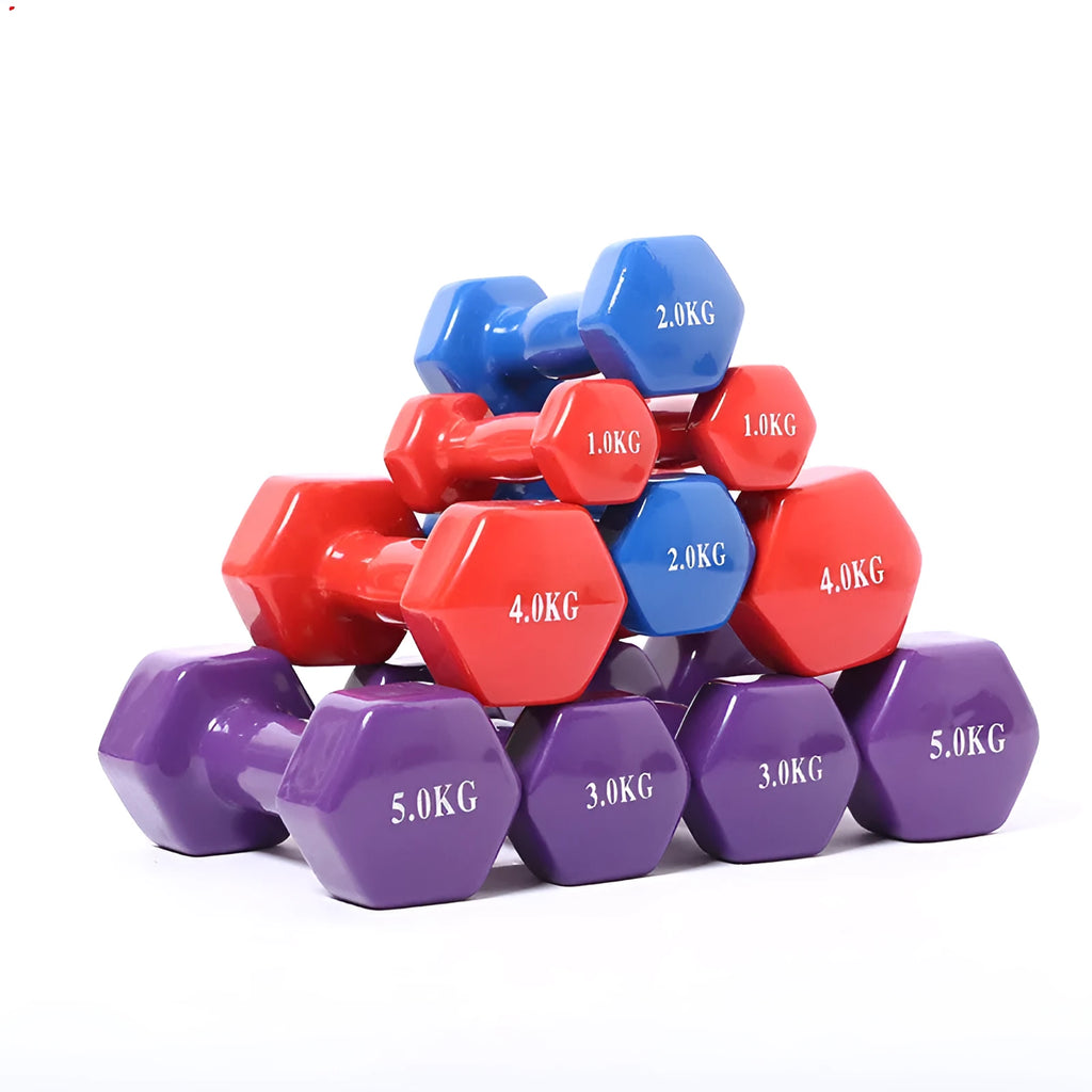 A set of bright red, blue, and green plastic fitness dumbbells with glossy finish on a wooden floor.