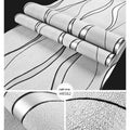 Close-up of light grey 3D curved stripe wallpaper with textured velvet finish.