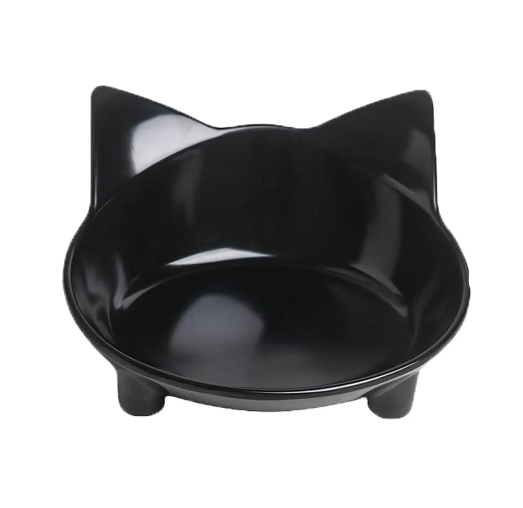A shallow black melamine pet bowl with a non-slip rubber base on a kitchen surface.
