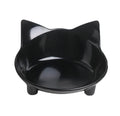A shallow black melamine pet bowl with a non-slip rubber base on a kitchen surface.