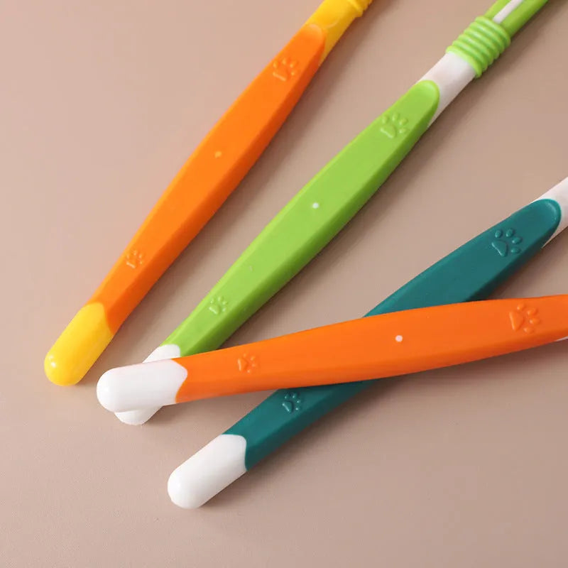 Plastic and nylon pet toothbrush in a sealed bag, colours include orange, green, and blue pink.