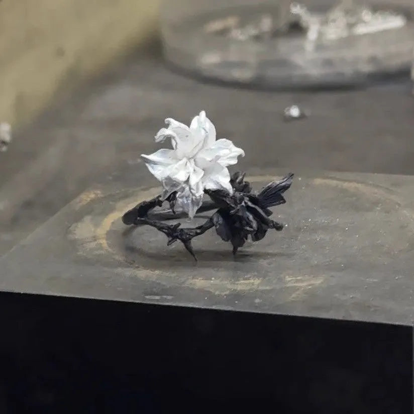 Bipolar Disorder French Simplicity copper ring in white and black with lily motif on neutral background
