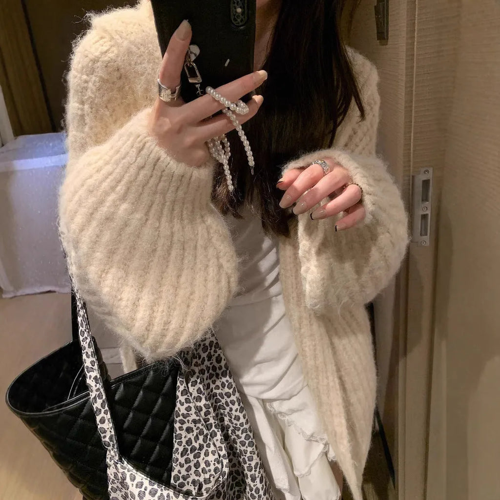 Woman wearing a dark grey retro knit Maillard pattern hooded cardigan