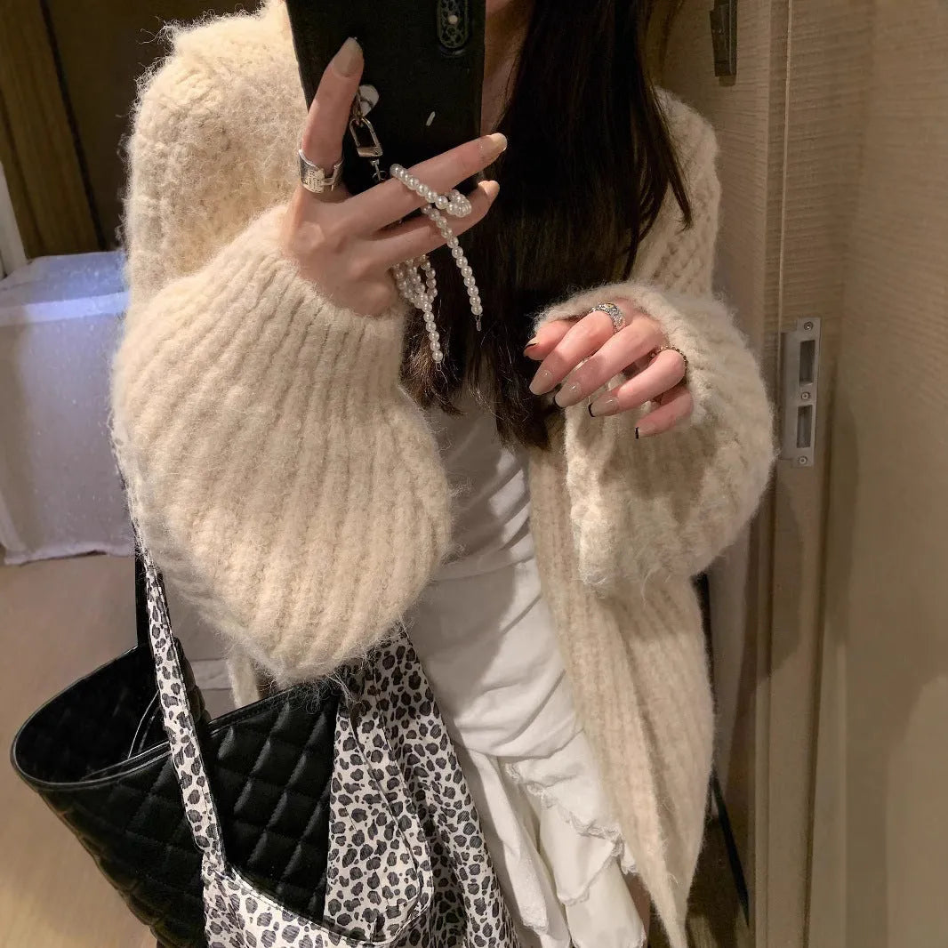 Woman wearing a dark grey retro knit Maillard pattern hooded cardigan