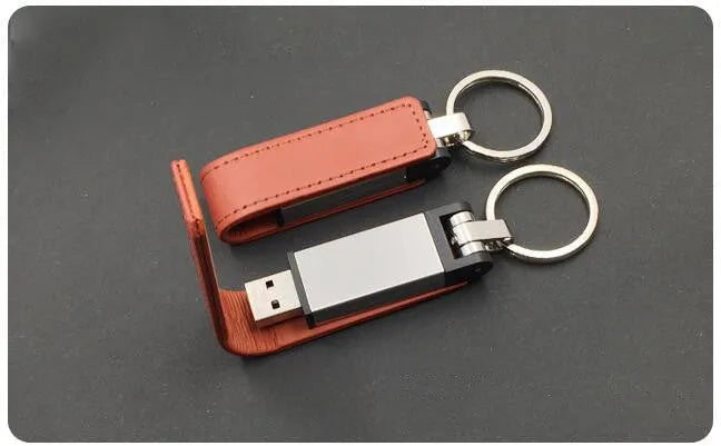 Leather USB 2.0 flash drive keychain in brown with keyring attachment on a white background