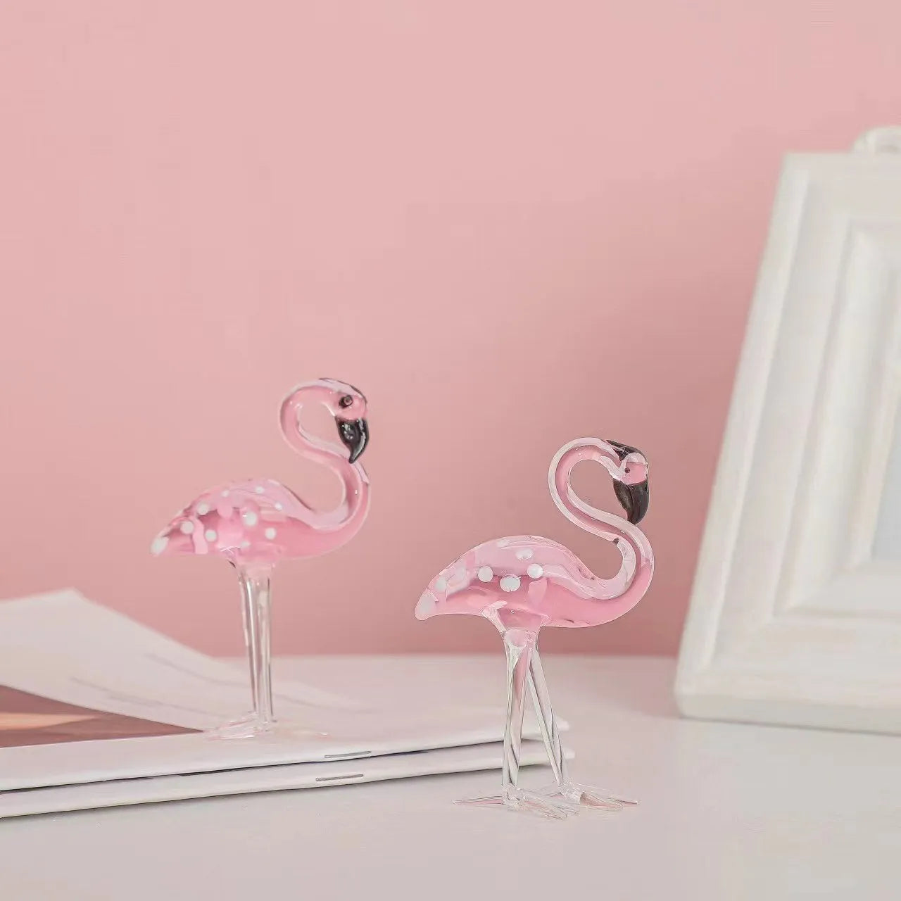 Pink crystal simulation flamingo decorative ornament on a table for home decor or gifting.