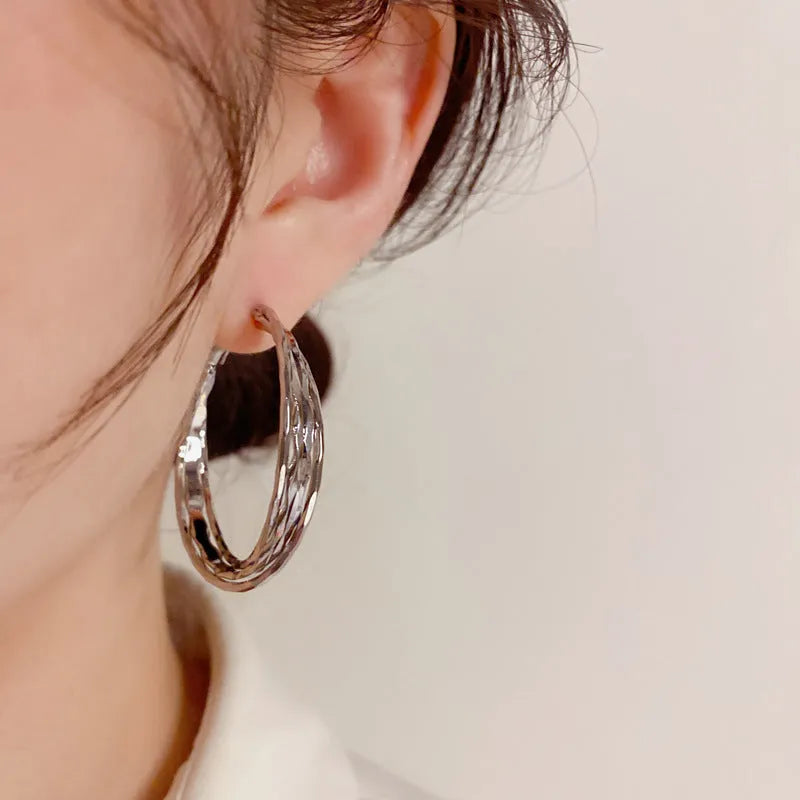 Simple metal twisted earrings for women, copper geometric round shape, available in gold or silver finish