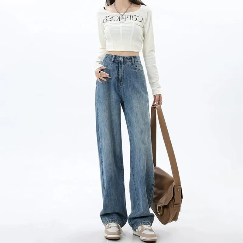 Woman wearing high-waisted retro blue wide leg jeans with a straight-leg cut.